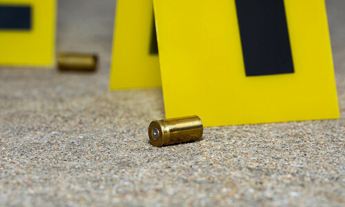 A picture of a crime scene with bullets on the ground.