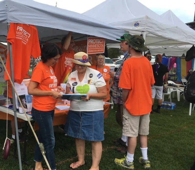 A group of people outside raising funds for a cause.